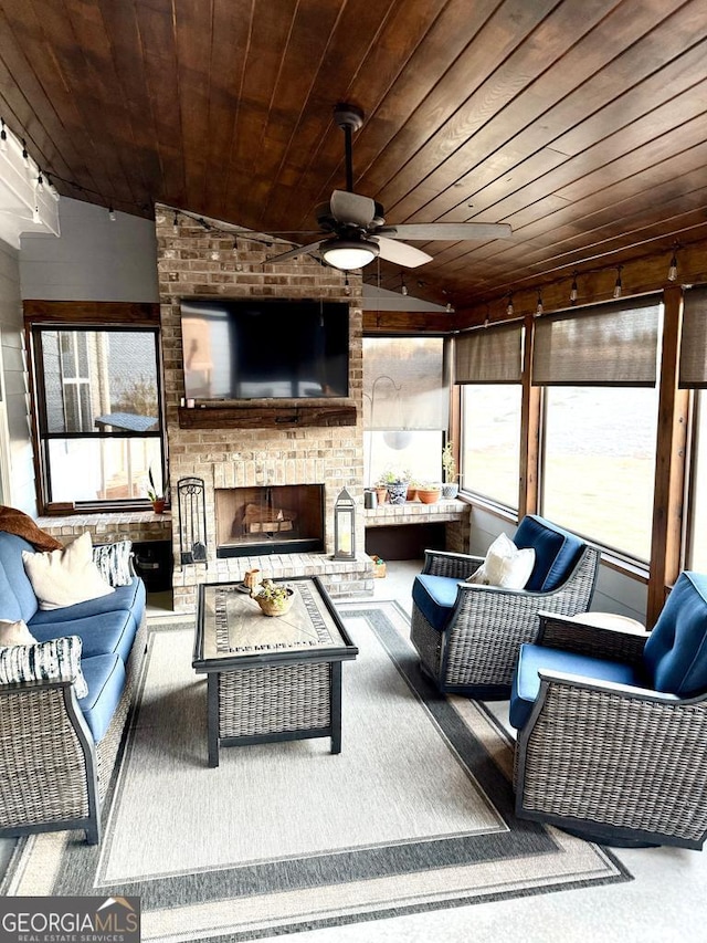 living room with ceiling fan, a brick fireplace, lofted ceiling, and wood ceiling