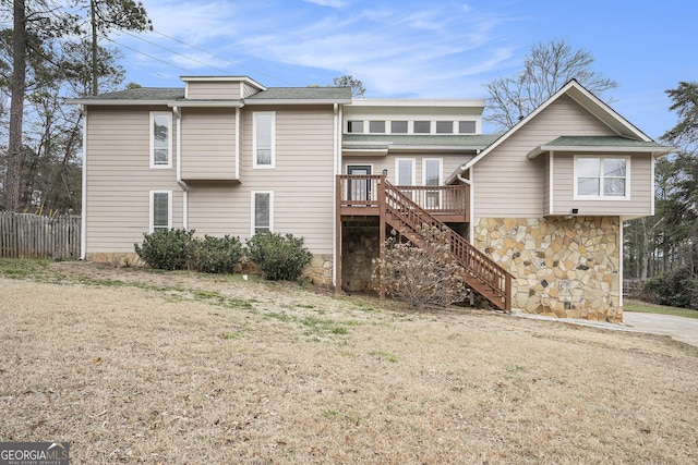 back of house featuring a yard and a deck