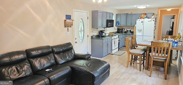 190 Creekwood Rd, Winder, GA 30680 - kitchen featuring white appliances, open floor plan, gray cabinets, and light wood-type flooring