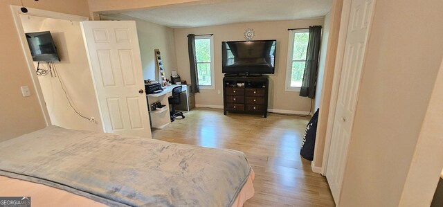 190 Creekwood Rd, Winder, GA 30680 - bedroom featuring baseboards, multiple windows, and light wood-type flooring
