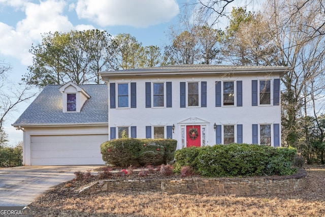 colonial inspired home featuring a garage