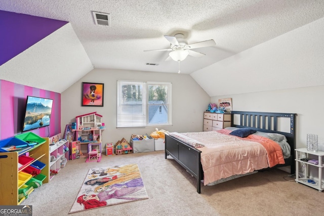 bedroom with light carpet, vaulted ceiling, and a textured ceiling