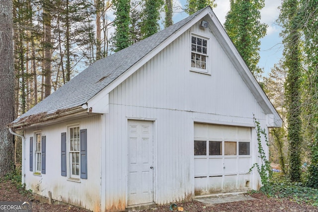 view of property exterior with a garage and an outbuilding