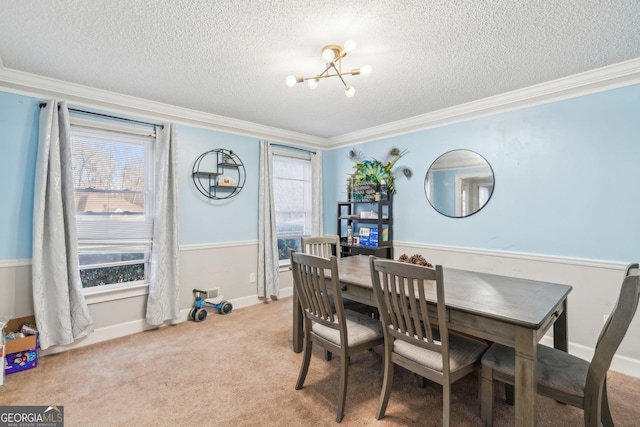 dining room featuring crown molding, light colored carpet, and a chandelier