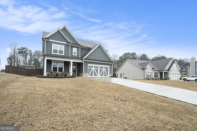 craftsman inspired home with a garage, a front yard, and covered porch