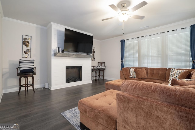 living area featuring ornamental molding, dark wood-type flooring, and a fireplace