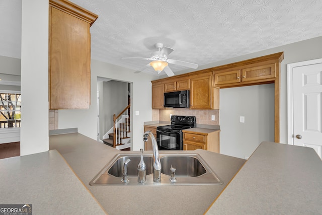 kitchen featuring tasteful backsplash, sink, ceiling fan, black appliances, and a textured ceiling