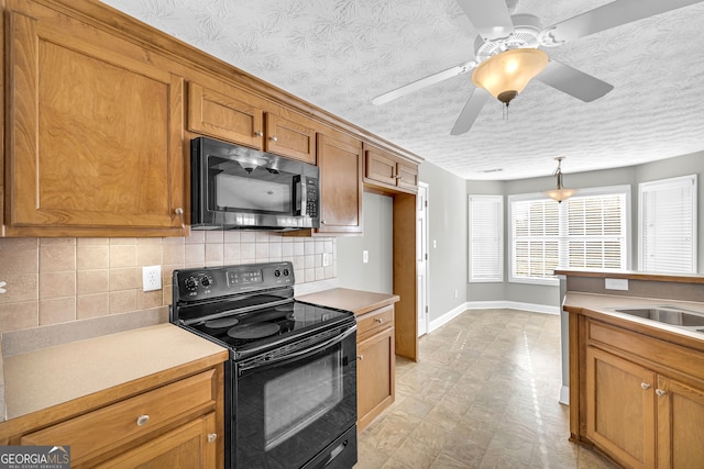 kitchen featuring backsplash, electric range, decorative light fixtures, and a textured ceiling