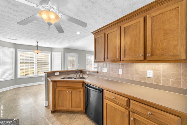 kitchen featuring tasteful backsplash, a healthy amount of sunlight, dishwasher, and sink