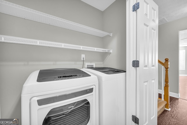 washroom featuring hardwood / wood-style floors and washer and clothes dryer