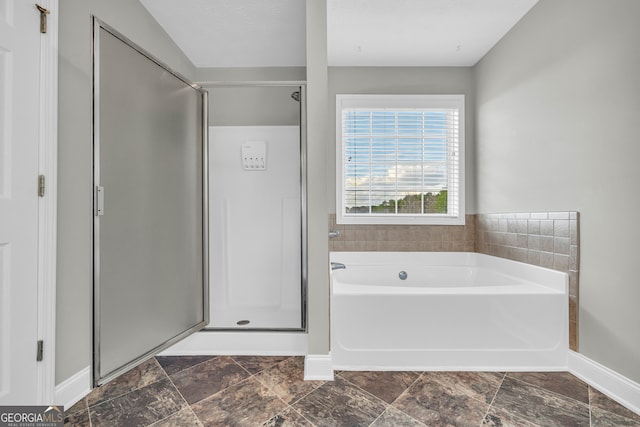 bathroom featuring separate shower and tub