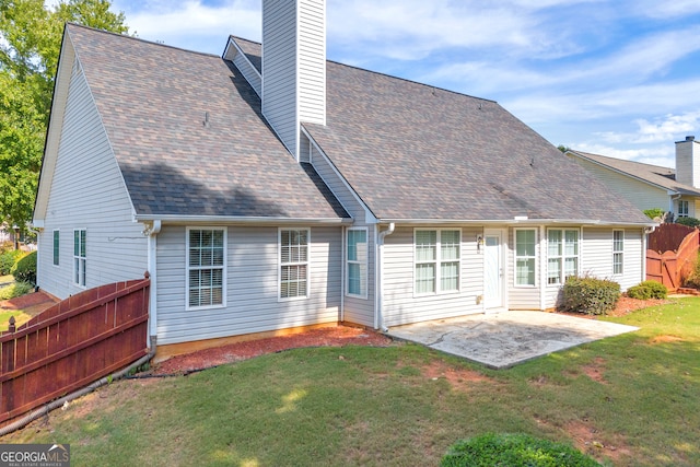 back of property featuring a patio and a lawn