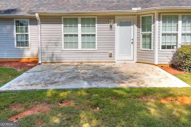 view of exterior entry featuring a patio area