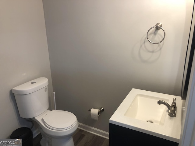 bathroom with vanity, hardwood / wood-style flooring, and toilet