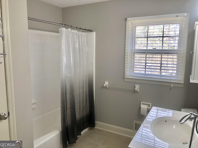 bathroom featuring tile patterned floors, vanity, and shower / bath combo