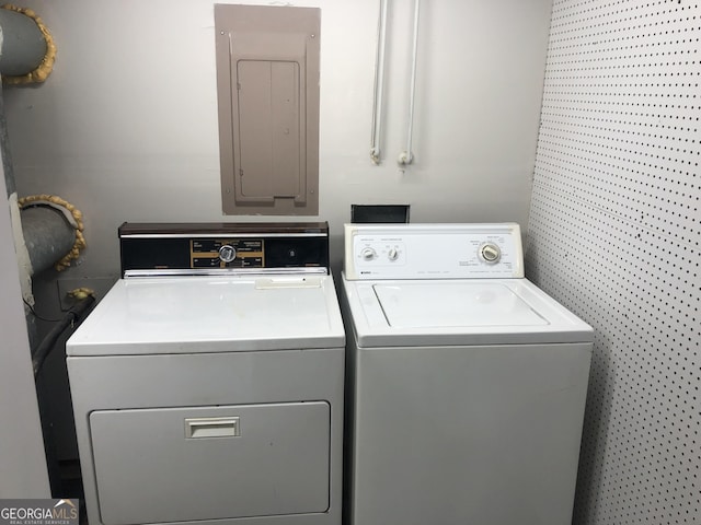 clothes washing area featuring separate washer and dryer and electric panel