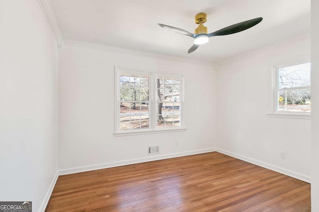 spare room with crown molding, ceiling fan, and wood-type flooring