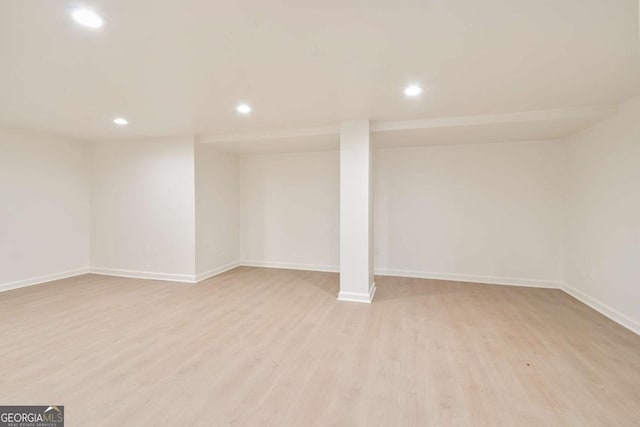 basement with light hardwood / wood-style flooring