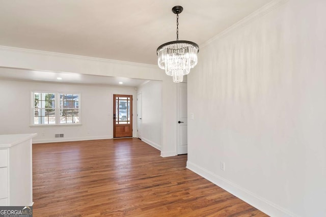 interior space featuring crown molding, dark hardwood / wood-style flooring, and a chandelier