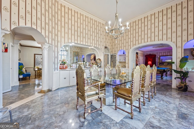 dining room with decorative columns, crown molding, and an inviting chandelier