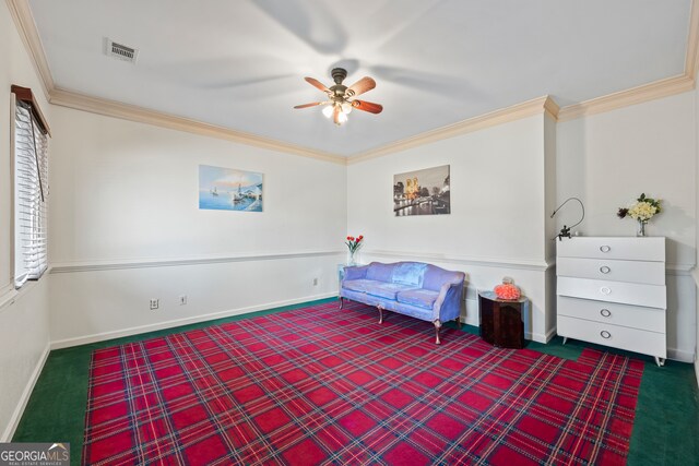 living area with ornamental molding, ceiling fan, and carpet