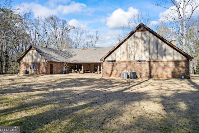 rear view of property featuring central AC