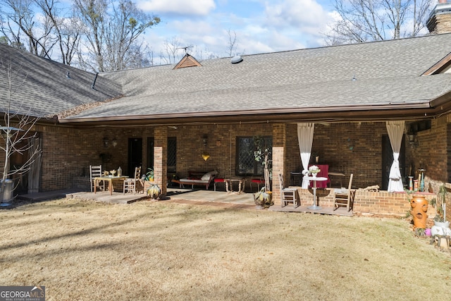 rear view of property featuring a patio and a lawn