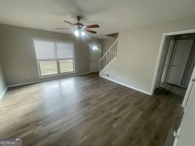 unfurnished living room with ceiling fan and dark hardwood / wood-style floors