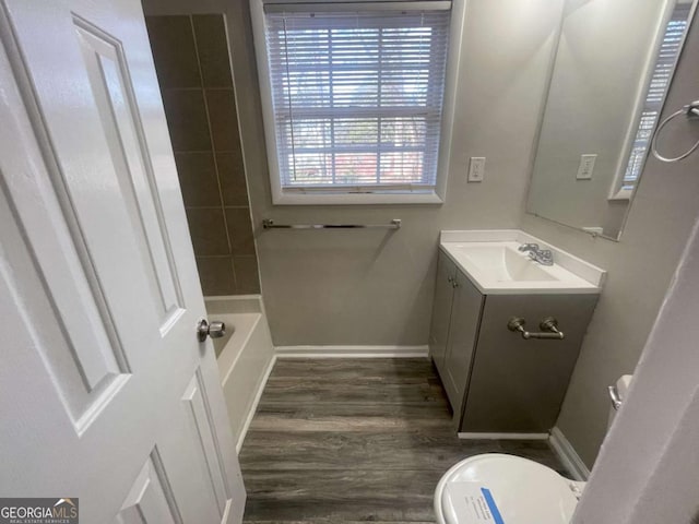 full bathroom with vanity, hardwood / wood-style flooring, plus walk in shower, and toilet