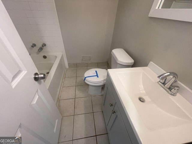 bathroom with vanity, toilet, tile patterned flooring, and a bath