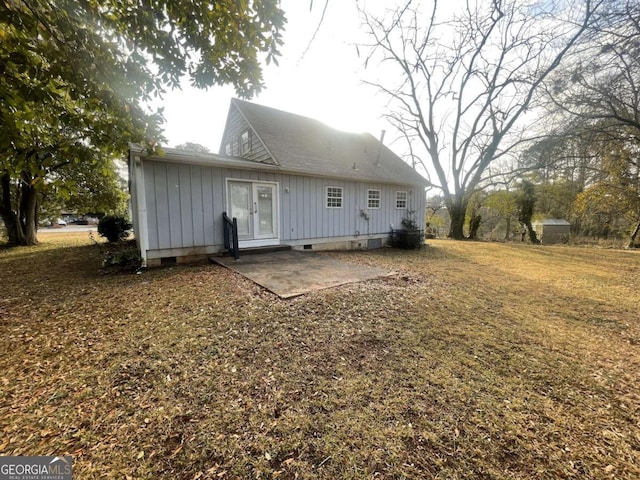 back of property with a yard and a patio area