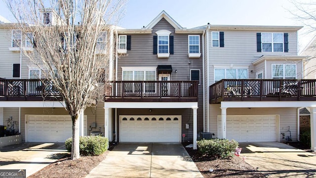 view of property with a garage and central AC