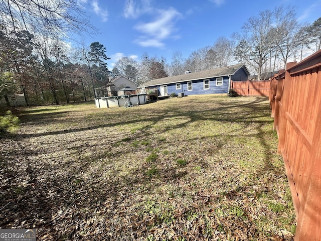 back of house with a covered pool and a lawn