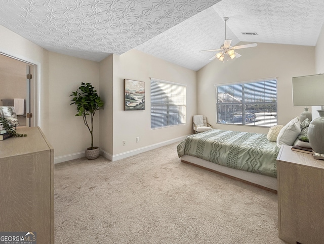 bedroom featuring baseboards, visible vents, light colored carpet, vaulted ceiling, and a textured ceiling