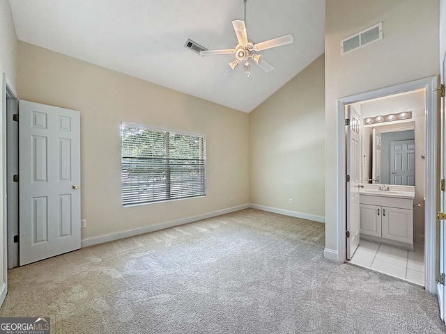 unfurnished bedroom featuring baseboards, visible vents, a sink, and light colored carpet