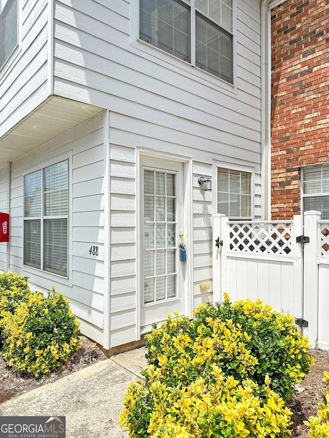 entrance to property featuring a gate and fence