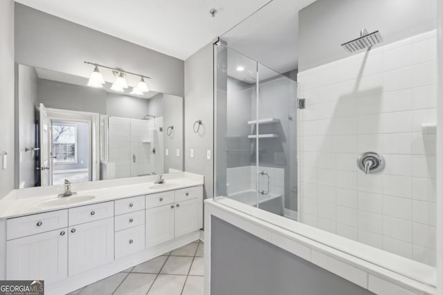 bathroom with vanity, a shower with shower door, and tile patterned floors