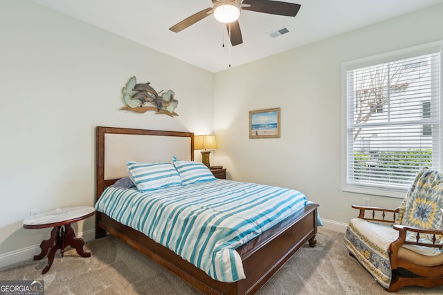 bedroom featuring ceiling fan and light carpet