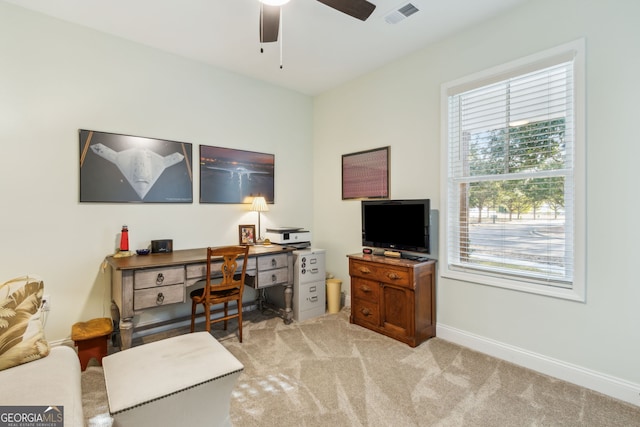 carpeted office space with ceiling fan