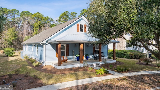 bungalow with a front yard and covered porch