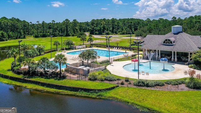 view of pool with a water view, a yard, and a patio area