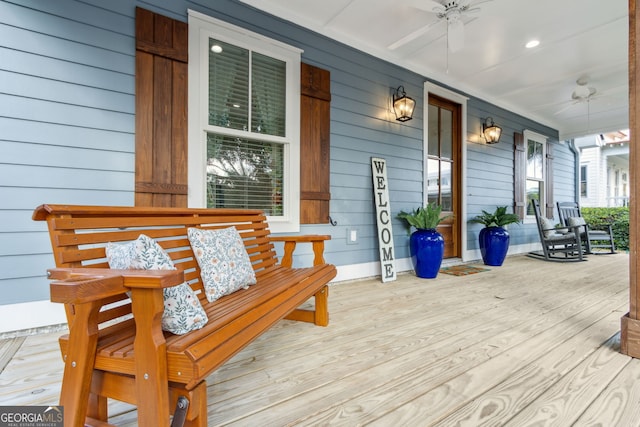 wooden terrace featuring ceiling fan and covered porch