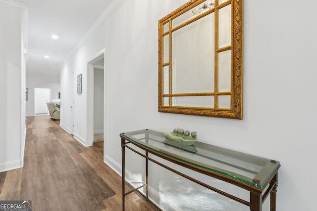 corridor featuring hardwood / wood-style flooring and ornamental molding