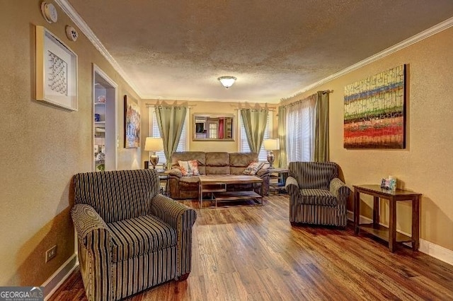 sitting room featuring wood-type flooring, crown molding, and a textured ceiling