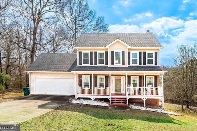 colonial inspired home featuring a garage, a front lawn, and a porch