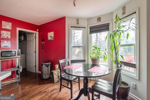 dining room featuring hardwood / wood-style floors and washer / dryer