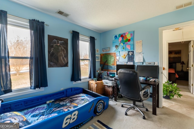 bedroom with carpet floors and a textured ceiling