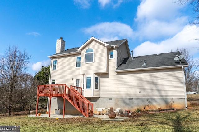 back of house with a wooden deck, a lawn, and a patio