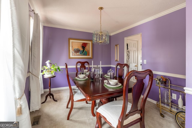 dining room with crown molding, carpet flooring, and a chandelier