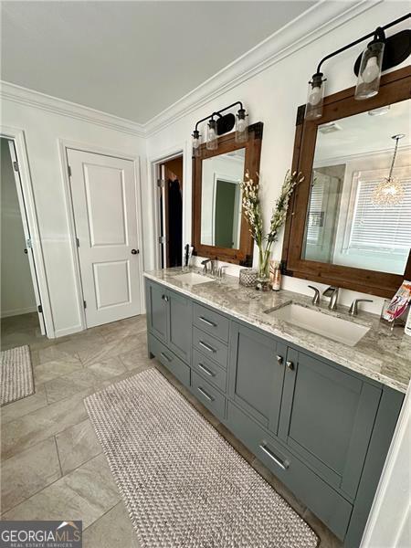 bathroom featuring crown molding and vanity